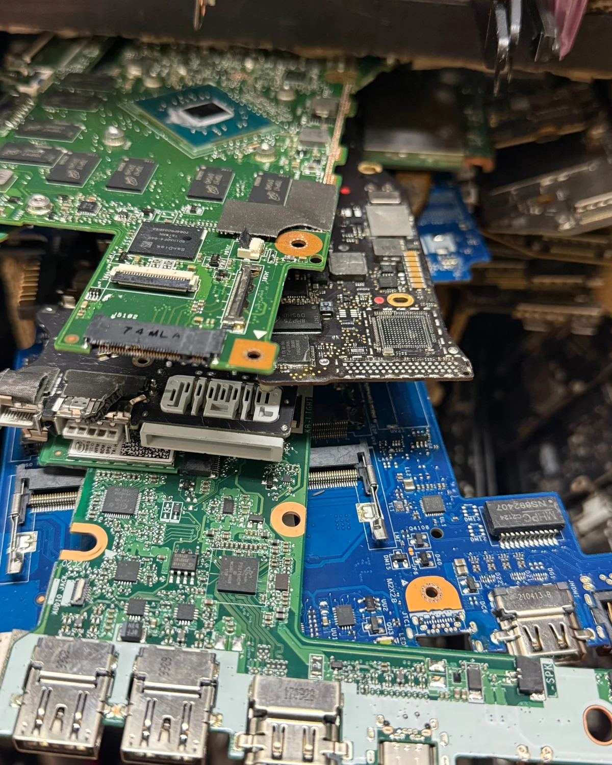 Computer and laptop logic boards at the Computer Pros repair bench